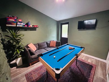 A game room with a pool table and a sofa at Stiniog Lodge in Blaenau Ffestiniog