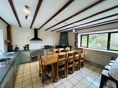 A kitchen with a dining table and chairs at Stiniog Lodge in Blaenau Ffestiniog