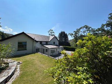 A house and garden with trees at Stiniog Lodge in Blaenau Ffestiniog