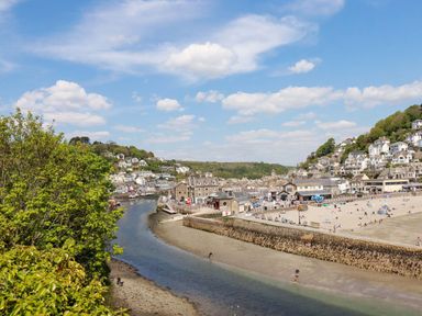 A view of a beach and river with houses near Pelynt near Looe