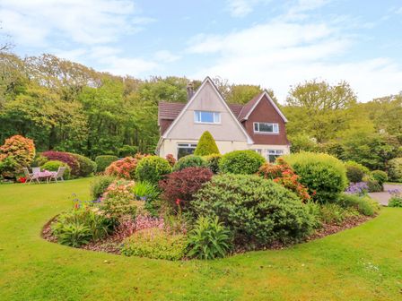 A house with a landscaped garden and outdoor seating area at Trevow in Camborne