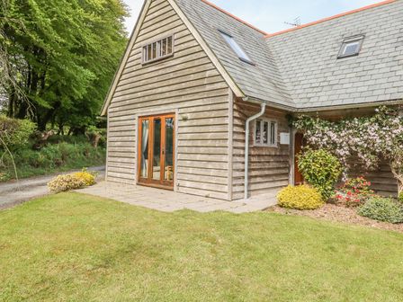 A wooden house with a tiled roof and garden in front at Trevinny Lodge No 37 Davidstow near Boscastle