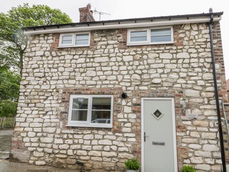 Stone cottage exterior with windows and a door at Chalkstone Cottage in Flamborough