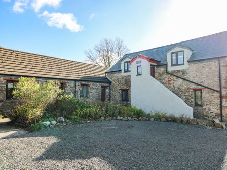 An exterior view of a stone building with a staircase at Cattle Shed near Narberth