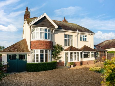 A house with a front yard and garage at Summerfield in Deganwy