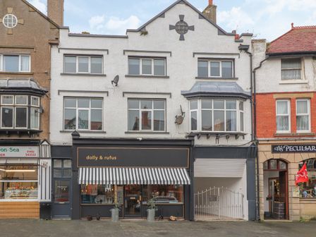 A street view of shops with a dolly and rufus store in the center and other shops on either side at Sea Breeze in Rhos-on-Sea