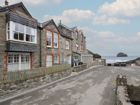 A view of buildings along a road near the ocean at Stargazy in Trebarwith Strand near Tintagel
