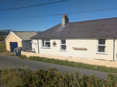 A house with a garage beside the road at Minydon in Fairbourne