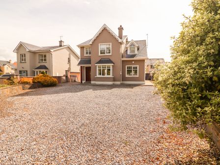 A detached house with a gravel driveway and shrubbery on the side at 4 Killimer Road in Kilrush County Clare