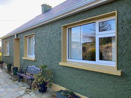 An outdoor area with a bench and windows at Sea View Hideaway in Lahinch, County Clare