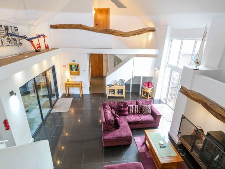 A living room with a sofa and table at Flint Barn in Knapton