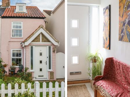 A pink house with a white door and a small garden with a white picket fence and an entryway with a red patterned bench and plants at 21 Florence Road in Pakefield