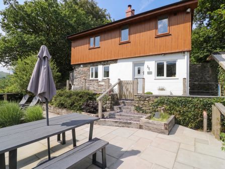 An outdoor view of a house with patio furniture at Pengeulan in Cemmaes