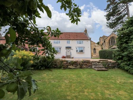 A house with a garden and trees at Weavers Cottage Carlton-in-Cleveland near Stokesley