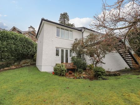 A white two-story house with garden and metal staircase at Hillhead in Ambleside