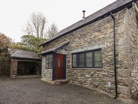 Stone house with a wooden door and window at The Old Chapel in Crook