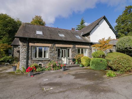 A house with a stone exterior and garden at Middlerigg in Troutbeck