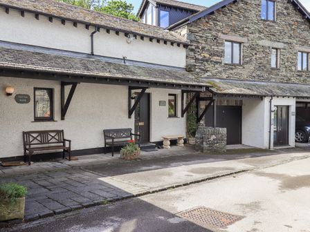 An outdoor area with benches and a stone wall at Ghyll Heights in Ambleside