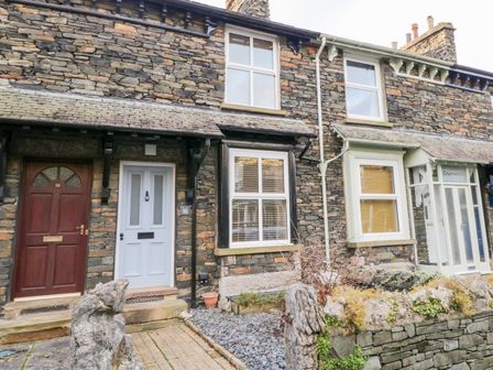 Stone cottages with wooden and painted doors and windows with blinds at Pottergill in Windermere