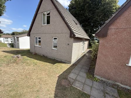 A house with pathway and grass at Hembry Meadows in Honicombe Park near Gunnislake