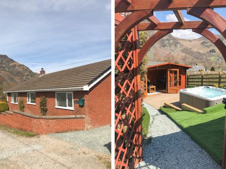 A brick house with a sloped roof and a small garden in front and a wooden pergola with a pathway leading to a wooden shed and a hot tub in a backyard with mountains in the background at Bryn Teg in Llangynog