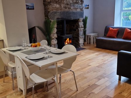 A dining room with a table and chairs and a fireplace at Annest in Bethesda