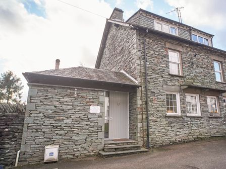 Stone house exterior with white door and windows at Plumblands in Chapel Stile