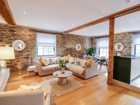 A living room with a sofa and coffee table at 9 The Pottery in Dartmouth