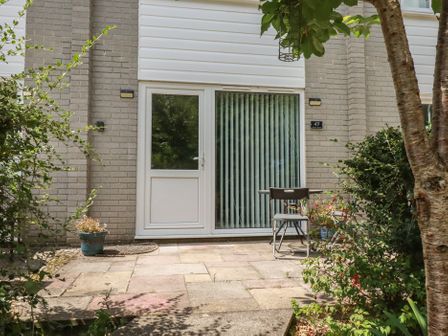 An outdoor entrance with a door and seating area at 49 Atlantic Reach Newquay