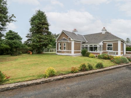 A house with a garden and trees at Churchfield House in Moygownagh near Crossmolina, County Mayo
