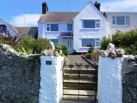 A house with a garden and gate at The Old School House in Cemaes Bay