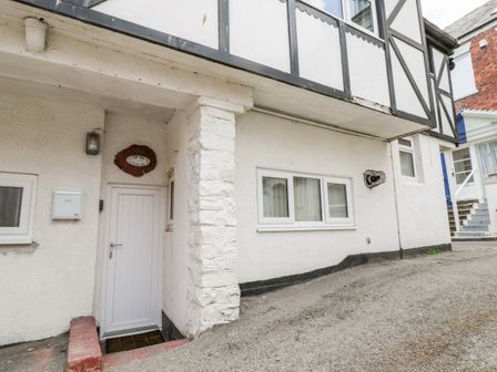Exterior of a white building with a white door marked 9A and surrounding windows at The Counting House in Whitby
