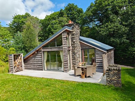 A cabin with a deck and outdoor seating area at The Badger's Shack, Garnett Bridge, Longsleddale. Near Kendal