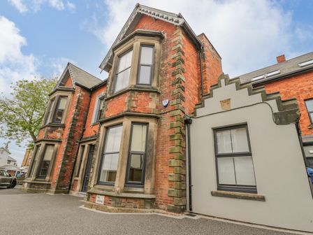 A red brick building with bay windows and a gray annex at Railway House in Scarborough