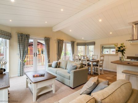 A living room with two sofas a coffee table and a dining table with chairs at Langdale Lodge Langdale 21 White Cross Bay near Windermere