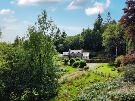 A cottage surrounded by trees and garden at Greffyn in Betws-Y-Coed