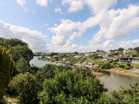 A river with houses and greenery on both sides at Rathillet in Feock near Truro