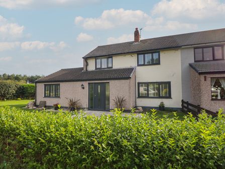 An exterior view of a semi detached house with hedge in front and a garden at 26 Hycemoor Way Bootle Near Millom