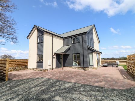 A modern two story house with paved driveway and wooden fence at Amal Anpras in Tintagel