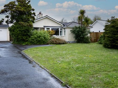 A house with a driveway and garage surrounded by trees and grass at Pencreek in Rock