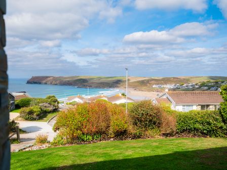 A view of the beach and houses from a garden at Windyhill in Polzeath