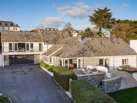 A large house with stone walls a tiled roof outdoor seating areas and a driveway at Landers Field in Rock