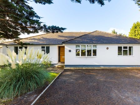 The front exterior of a single story house with a driveway and plants at The Garden House in Rock