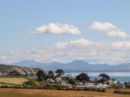A coastal village with houses near water and mountains in the background at The Anchorage in Abersoch