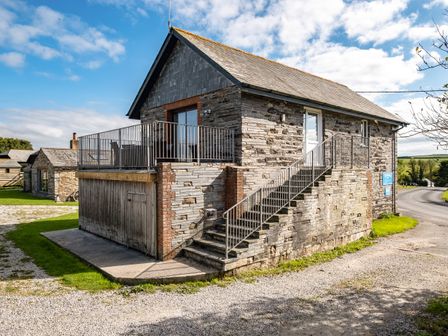 A stone building with an external staircase and metal railing in a rural setting at Swallow Cottage Trewetha Farm Trewetha near Port Isaac