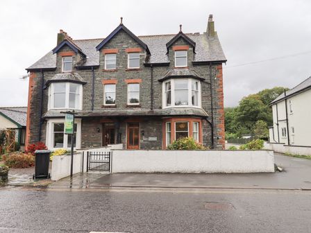 A house with multiple windows and a gate at Hazelmere in Keswick
