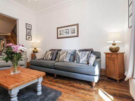 A living room with a sofa and coffee table at Charlotte House in Whitby