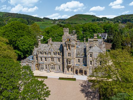 Stone mansion surrounded by trees and hills at The Mabel Suite Stone Cross Mansion in Ulverston