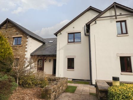 A house with stone and white walls and a small garden at Tilly Mint Cottage Nr Ullswater