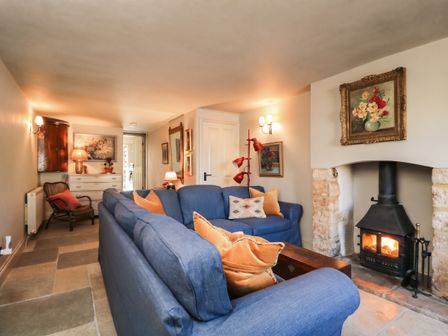 A living room with a sofa and fireplace at Mallards in Bourton-On-The-Water